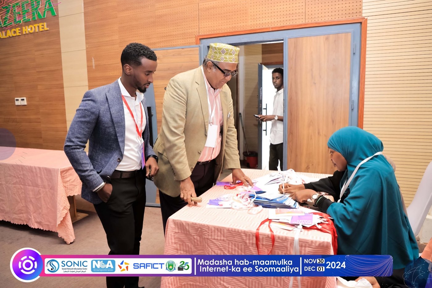 Participants collecting badges at the SIGF on-site registration desk